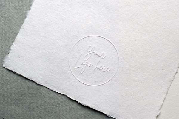 Raised impression embosser creating a subtle embossed design on white paper.