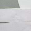 Rectangular paper embosser showing raised design on white sheet.