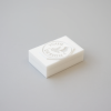 15mm mini soap stamp resting on a small white handmade soap bar.