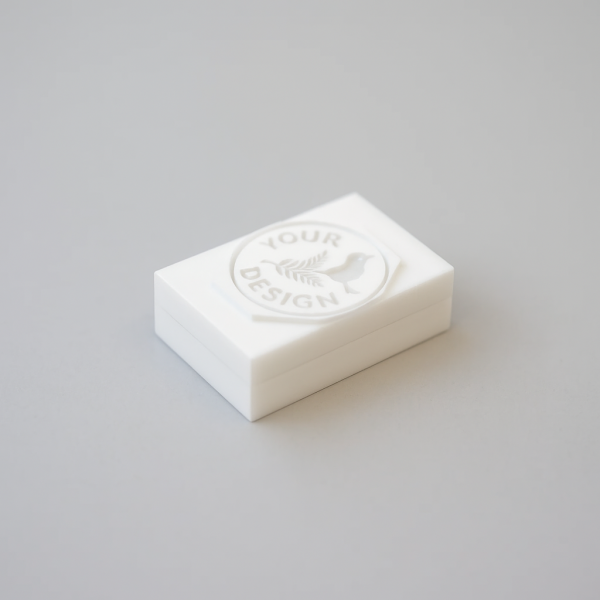 15mm mini soap stamp resting on a small white handmade soap bar.