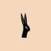 Rabbit silhouette rubber stamp on peach background.