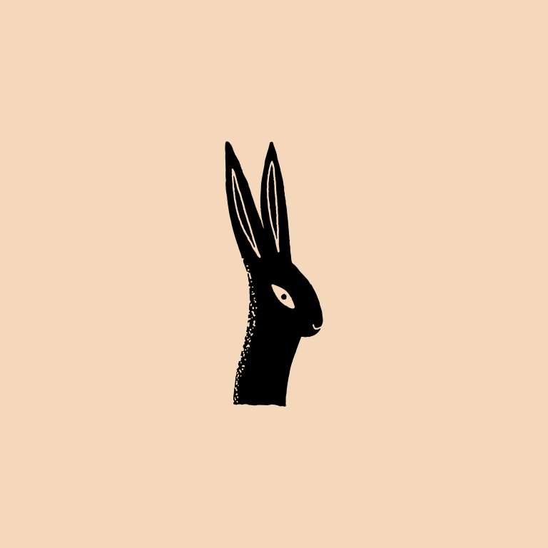 Rabbit silhouette rubber stamp on peach background.