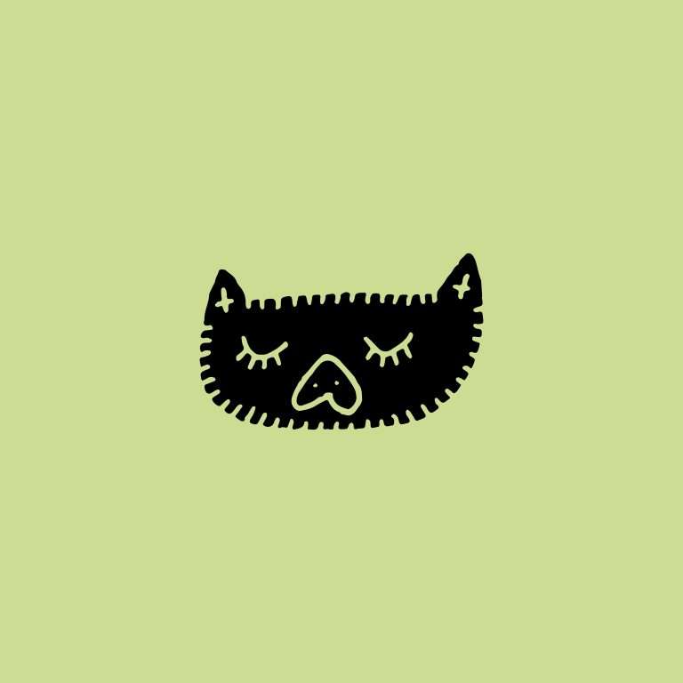 Cat face illustration rubber stamp on green background.