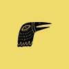 Rubber stamp with a bird head illustration on a yellow background.