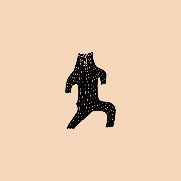 Rubber stamp with a bear illustration on a peach background.