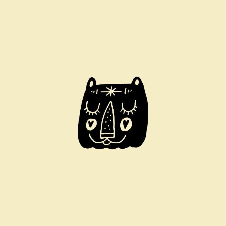 Rubber stamp with a cat illustration on a cream background.