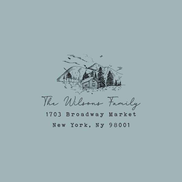 Return address stamp with illustrated mountains and custom family name.