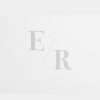 Embossed wedding initials on white paper.