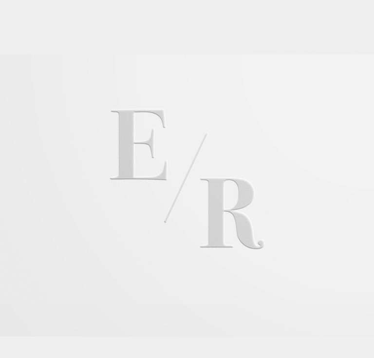 Embossed wedding initials on white paper.