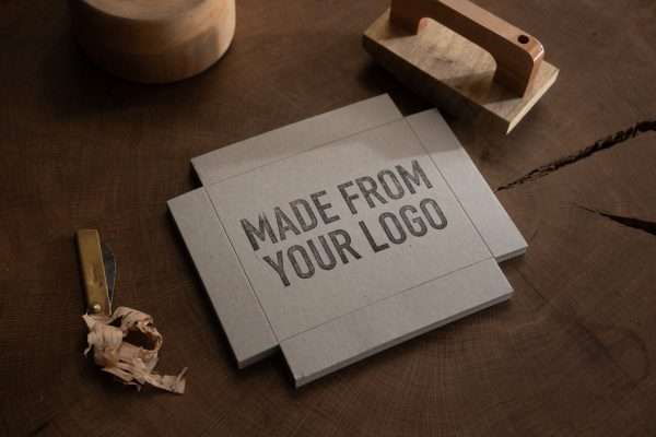 Lifestyle photo of Expressionery logo rubber stamp beside packaging materials.