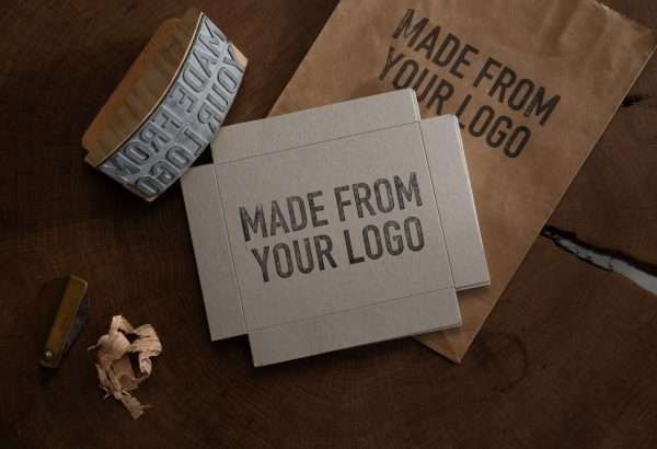 Expressionery custom logo rocker stamp used on kraft packaging box.