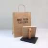 Large logo rubber stamp with logo stamped on paper bag.