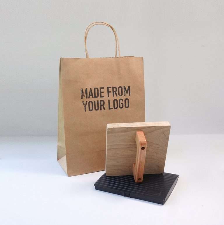 Large logo rubber stamp with logo stamped on paper bag.