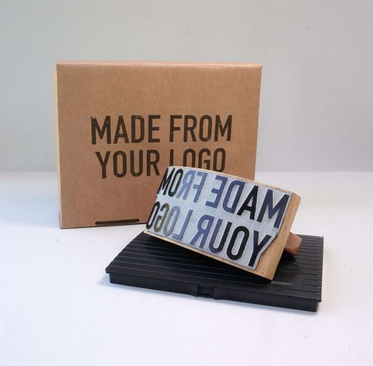 Expressionery wooden rocker rubber stamp beside packaging box.