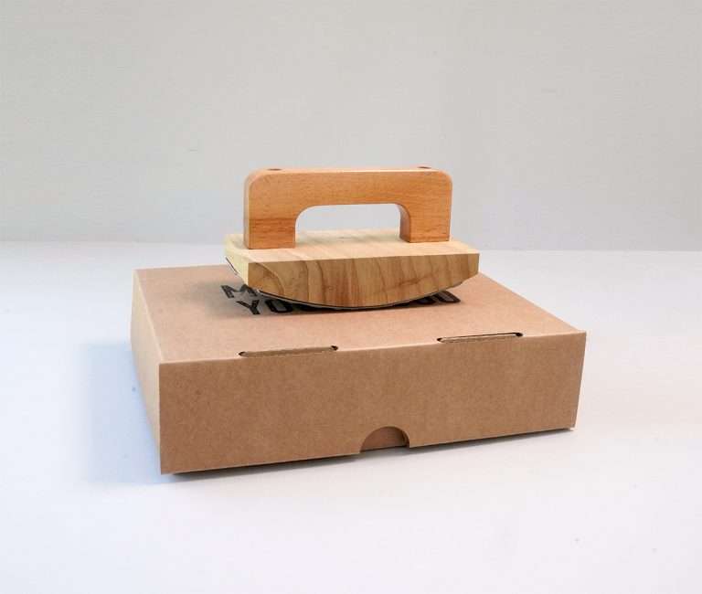 Expressionery rocker logo rubber stamp on cardboard packaging.