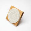 Wooden logo rubber stamp with engraved round design and handle.
