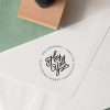 Expressionery round address rubber stamp with inked impression on white envelope.