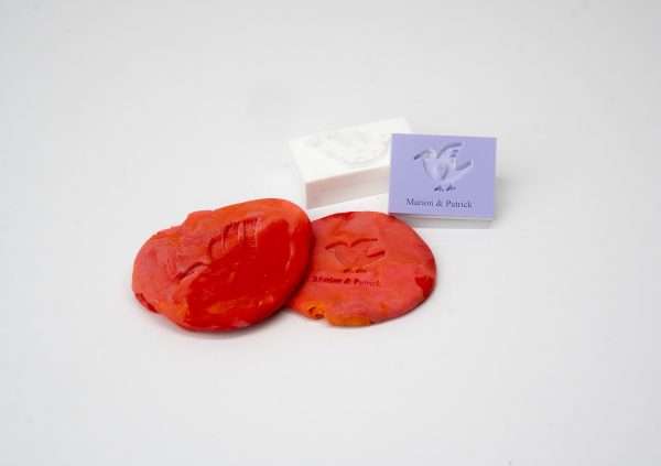 Expressionery playdough rubber stamp with red playdough impression.