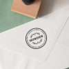 Traditional address rubber stamp with classic type layout on paper.