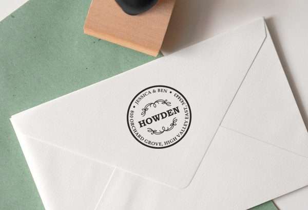Traditional address rubber stamp with classic type layout on paper.
