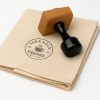 Round fabric rubber stamp with wooden handle placed on stamped fabric.