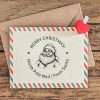 Custom Christmas rubber stamp featuring Santa Claus design on envelope.