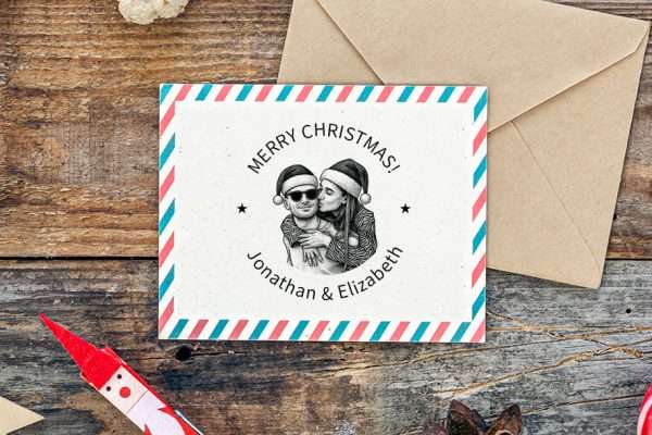 Custom portrait Christmas rubber stamp on festive envelope.