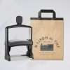 Large signature self-inking stamp with kraft paper pag on white background.